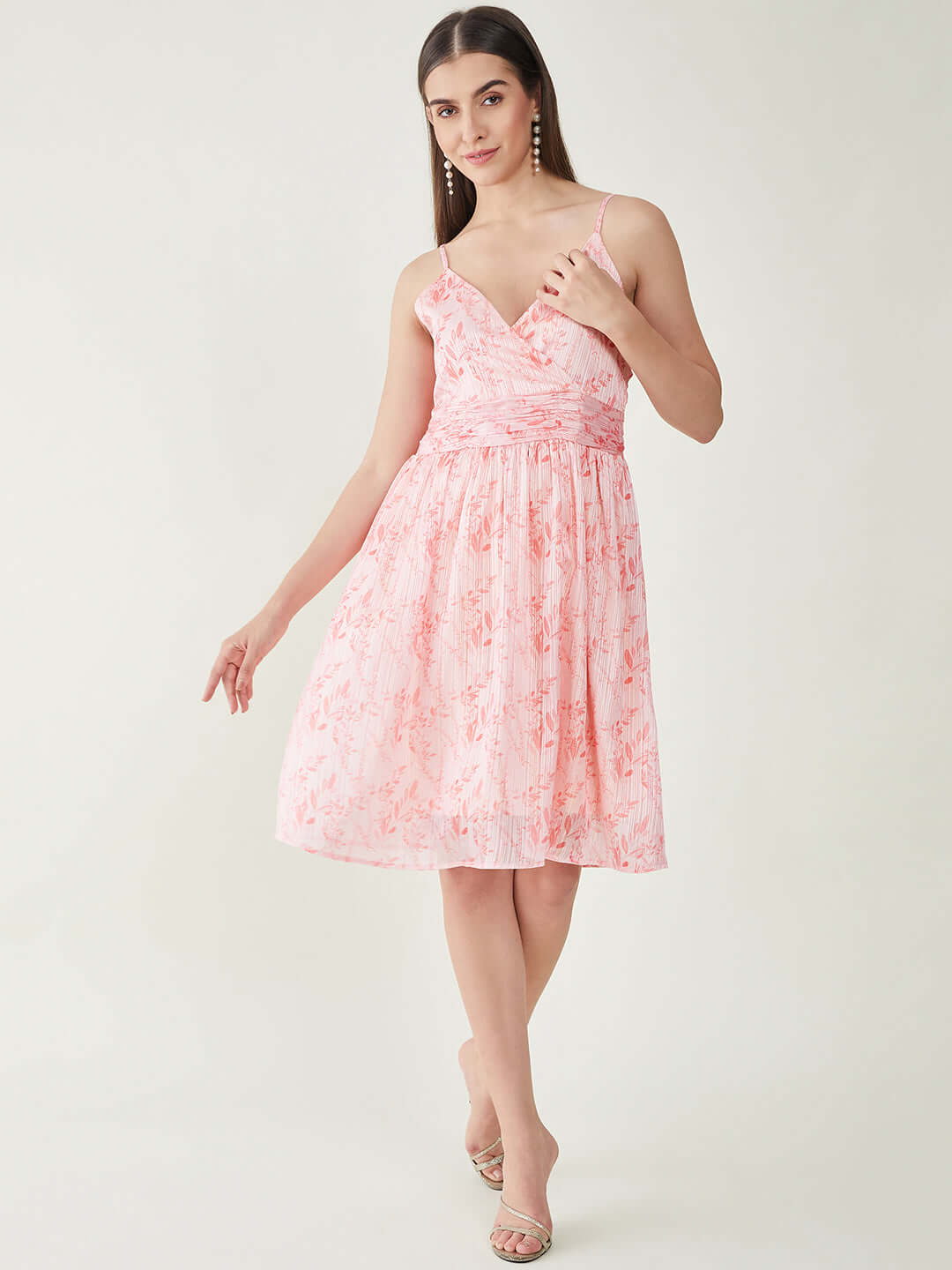 Woman wearing Pink Lurix Floral Print Dress with shoulder straps and flared hem, perfect for parties and casual outings.